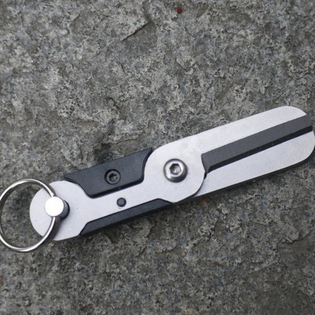 Outdoor portable survival scissors, compact climbing gadget designed for cutting and emergency use.
